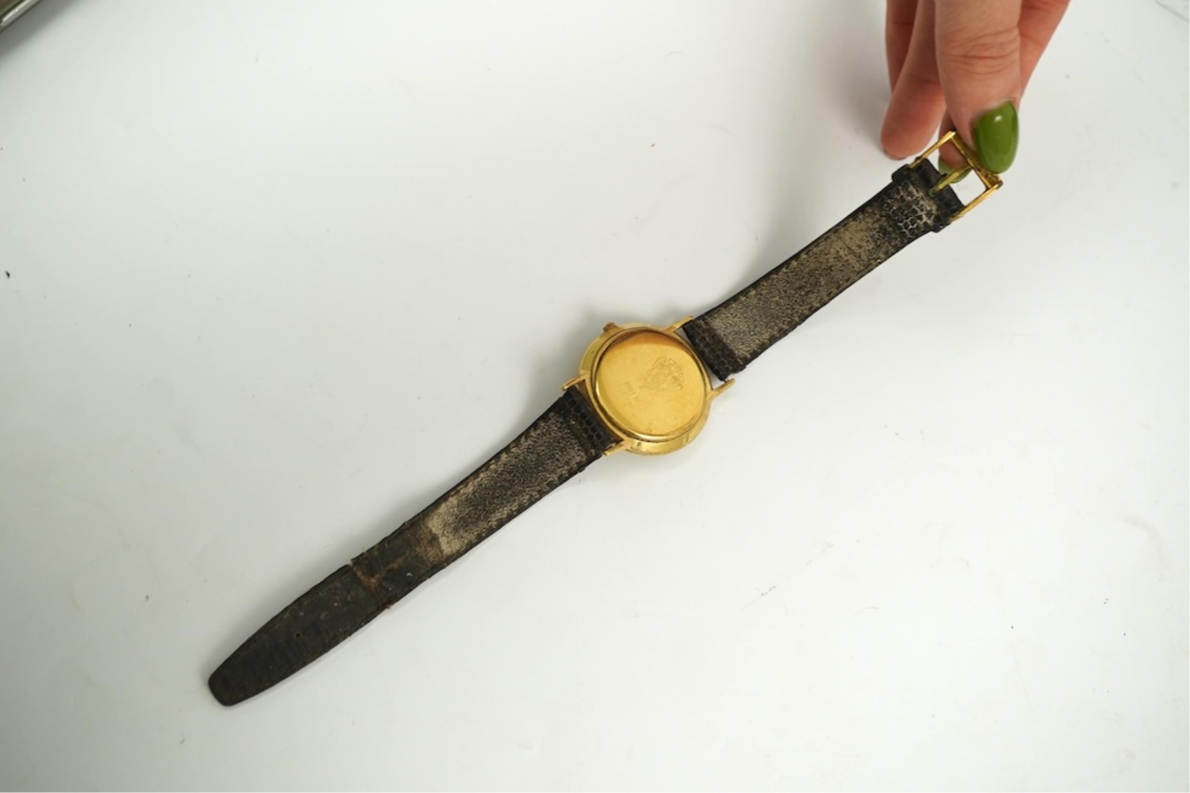 A gentleman's recent 18k gold electro-plated Raymond Weil quartz dress wrist watch, case diameter 33mm and a similar Gucci quartz dress wrist watch.